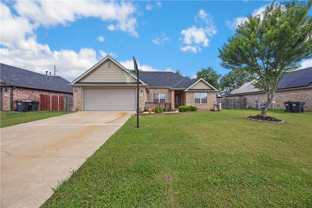 Beautiful all-brick 3 bed, 2 bath home with 2-car garage located in a desirable subdivision with quick access to Hwy 49, making commuting to Bentonville, Rogers, or Fayetteville convenient. This split floor plan offers a formal dining area that could also serve as an office, playroom, or flex space. No carpet throughout, the flooring consists of tile and wood. Kitchen features granite countertops, newer microwave, electric range, and a new dishwasher to be installed soon. Spacious primary suite includes a jetted tub, separate shower, double vanity, private toilet room, and walk-in closet. Secondary bedrooms are generously sized. Recent updates include new roof in 2025, water heater in 2023, new garbage disposal, new bathroom faucets, newer shower head, and fresh mulch at the front entrance. Fully fenced backyard with covered patio perfect for relaxing or entertaining. Don’t miss out on this great home — call today to schedule your private showing!