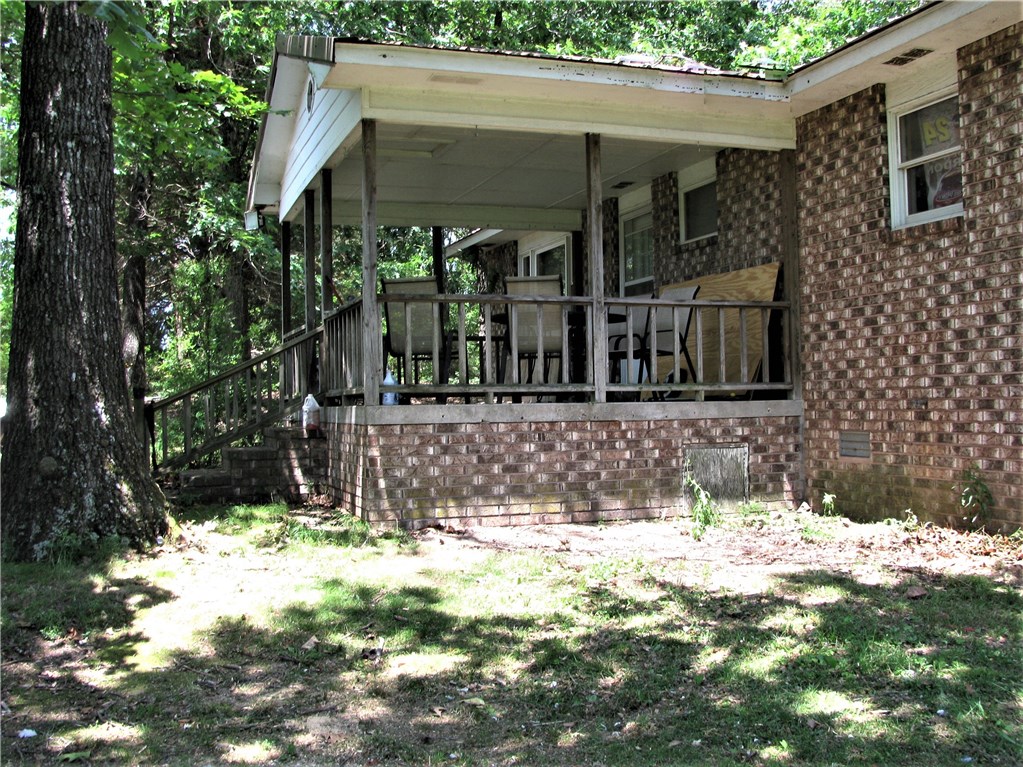 Brick House, Metal Roof, Large Front Porch, 2 Decks, Storage Building, Pole Shed, 3 Beds, 2 Baths, Central Heat/Air (2 yrs old). Electric Water Heater. In addition to Propane, Furnace can heat using wood. Carroll Electric, Septic, Garfield Rural Water. House currently occupied by long-time tenant. House in a secluded setting, large level yard, many beautilful trees. 47.83 acres; level & rolling pasture with nice wooded areas (22.83 acres wooded, 25 acres pasture). Fenced. 3 Ponds. Currently leased/cattle.