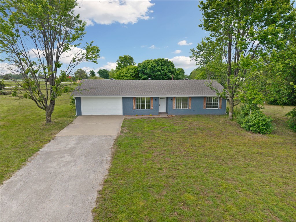Picture yourself enjoying your morning coffee on your covered back patio on your flat, level, cleared 2 acre lot that is fully fenced! This home has been recently painted and is move in ready. Featuring 3 bedrooms, 2 full bathrooms and a flex room for convenience. A large kitchen featuring granite countertops and stainless steel appliances. With a large living area, this home provides a functional floorplan with thoughtful finishes. Attached 2 car garage is partially converted and allows for storage. Bring your farm animals and raise them here! A chicken coop already on site ready for your flock! Perfect for a hobby farm, 4H or whatever you fancy with a section fenced for livestock. A designated garden area with water and plenty of room for a shop! Level, fully fenced, clear acreage is a rare find in NWA! Don't miss your opportunity to get a slice of country living while still being close to all things NWA and only 10 min to center of Tontitown. Located in Springdale school district. Schedule your showing today!