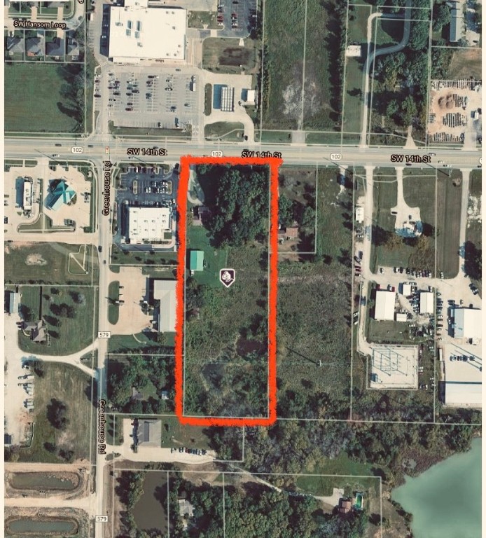 Check out this Great location, across from Neighborhood market and next to Starbucks! 5 Acres located on Hwy 102 with 266 foot of Hwy frontage. Value in the land and shop.  40 X 60 shop. City water but also well on site. Currently residential but could be made commercial. Still Rural according to county records. NO value to house. Property has not been annexed into city so there are many options for this property.