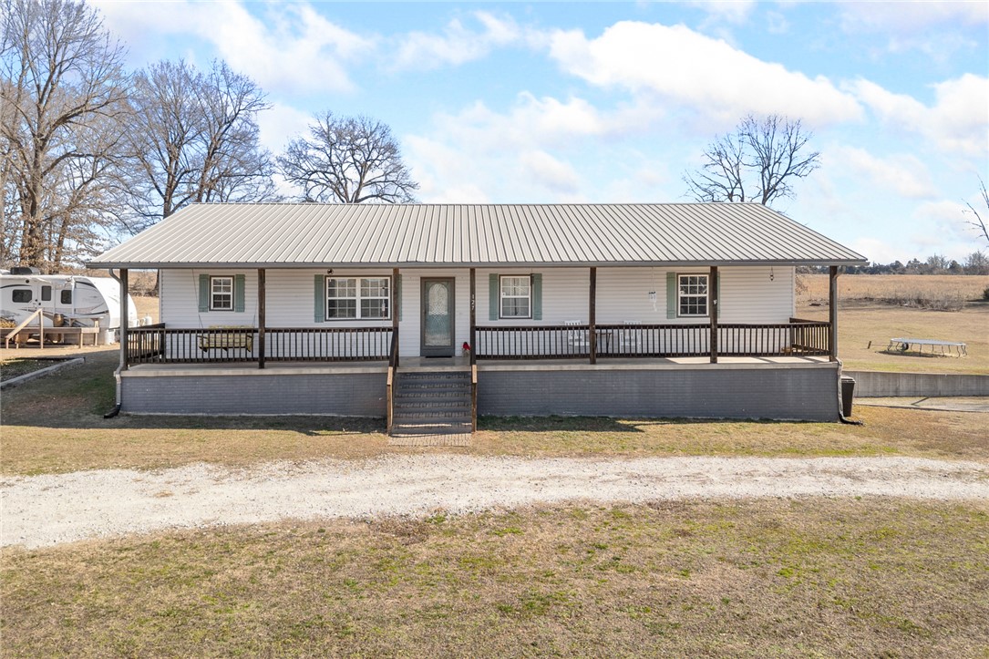 What a place!!  1,800 finished sqft on the main level plus an additional 1,920 heated/cooled sqft in the basement = tons of space plus a chance to finish the basement as you wish!  Come take a look at this beautiful 4 bedroom, 3 bathroom home sitting on 2.5 m/l acres with views of rolling pasture in the Western Grove school district.  On the main level you have 3 beds and 2 full baths.  The primary bedroom suite has 2 walk-in closets, is oversized and a step in shower.  The basement has 1 bed, 1 full bath, safe room, bonus room and more! The covered front porch and covered back deck are sure to please your family along with the garden area, basketball goal and RV parking.  Additional details you will appreciate; a FEMA certified safe room in the basement, spray foam insulation, 2 stall - 2 car garage with insulated doors, aesthetic circle driveway, the home is wired for a generator, oversized bedrooms, very spacious laundry room with bar top for easy folding/sorting, a utility sink and waterproof vinyl flooring.