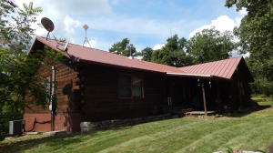 Nice Cedar Log Home on about 5 acres wooded and private, no neighbors in sight, located just over 5 miles South of Berryville. 3BR, 2BA home with open floor plan living, dinning, kitchen with vaulted ceiling, split plan with master bed and bath separate, large pantry, family room, office, covered porch, CHVAC with wood stove. Detached metal building insulated and wired. Come Take a Look!