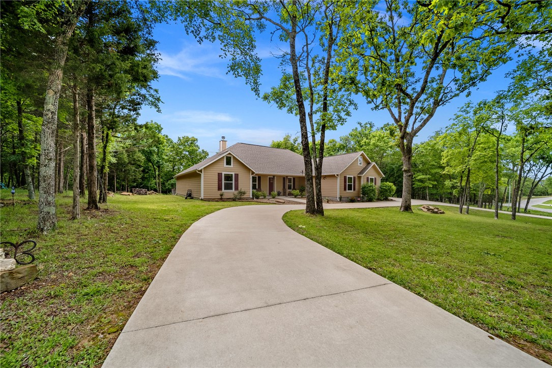 Built in 2022 and perfectly positioned on a level 1.12-acre lot atop Whitney Mountain, this stunning 4-bedroom, 3.5-bath home in Lost Bridge Village offers the ideal blend of modern comfort and lake community living. Designed with space and flexibility in mind, the home features two luxurious primary suites, making it perfect for guests or multi-generational living. Bright, oversized windows fill the home with natural light and showcase the peaceful setting. The open-concept layout flows beautifully for entertaining, while quality finishes and thoughtful design create a warm, inviting atmosphere throughout. Enjoy the amenities of Lost Bridge Village, including a community pool, pickleball courts, clubhouse, playground, and close driving access to Beaver Lake. Whether you're looking for a full-time residence or a lake-area retreat, this newer home offers the perfect combination of comfort, convenience, and community.