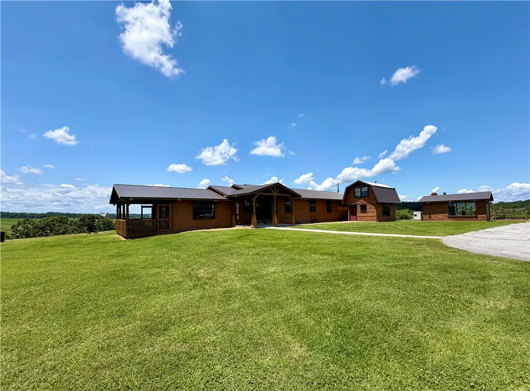 This beautiful property which is close to Rogers, Fayetteville, Springdale, and Eureka with its secluded feel on 45 rolling acres could be the perfect vacation rental, retreat center, small summer camp, dude ranch or hobby farm. It has a beautiful home with huge 5 bay garage with a guest house/caretakers quarters. It would make an excellent produce farm. The entire property is fenced but not cross fenced. The two story stand alone office/studio/storage facility is such a flexible building - it could be a check in facility or anything else you could imagine. The property has new HVAC units and new roofs (2024) and a large Generac generator which will run the entire compound. The 360 degree views from atop the beautiful mountain are some of the most quiet and serene you will ever see. Close to Hobbs State Park and 13 miles from Eureka.