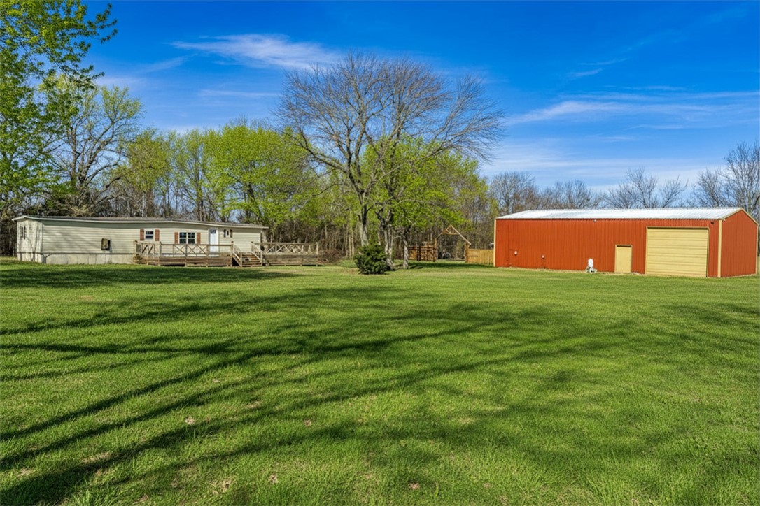 Discover an exceptional commercial/residential opportunity on 1.36 acres in Lincoln, Arkansas! This mixed-use property on W Holt Road features a large 40x60 shop building complete with a bathroom and office space—everything you need to start your business from day one. The property offers excellent infrastructure with public water, existing septic, and electric service already available. Situated on open, level terrain with three-side fencing, the land features a pond and wet weather creek adding natural beauty. Paved road frontage ensures convenient access, and there's a manufactured home on the property providing additional flexibility. Located in the Lincoln School District, this turnkey property combines peaceful rural surroundings with quick connectivity to Northwest Arkansas. Whether you're planning a contracting business, automotive shop, or storage facility, this property is ready for you to make it your own!
