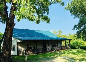 Beautiful farmette/horse property minutes from Harrison welcomes you to the Scenic Ozark Mountains. Pretty 4 BR 3 BA home features an open floor plan w/large great room, stylish cabinetry with granite counter tops, wood & tile floors, abundant windows to enjoy the views and covered porch. Detached double garage and 17'4 x 14'10 studio, office, etc with 1/2 bath. 3 stall pole/horse/or equipment barn, shed, 6 pretty pastured acres with scattered trees, pond, and seasonal creek. This one deserves your attention! Check it out!