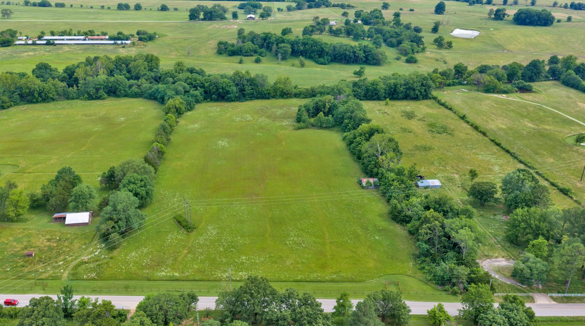 A great clear 11.1 acres on public paved road 3.6 miles from I-49, 4 miles from Greenland, and 4 miles from Prairie Grove. Cleared and in good pasture. Perfect for a new home and farm possibilities. The home at 11023 Illinois Chapel Rd must sell first.