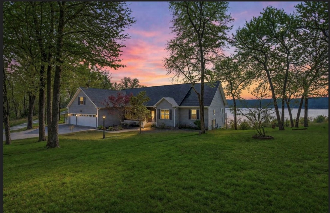 Enjoy stunning year-round views of Beaver Lake from this spacious and well-equipped lakefront home, complete with an owned boat slip with lift in the community dock and an optional pontoon boat—perfect for lake living. From the expansive decks, take in southwest-facing views and breathtaking sunsets over the water. There’s plenty of room to spread out. The main level offers a primary bedroom and bath, office, kitchen, and formal dining room, along with a private apartment with its own living room, full kitchen, bedroom, and bathroom—ideal for guests or extended family. The lower level features a family room with wet bar and fireplace, plus two bedrooms and two full bathrooms. Additional highlights include a three-car garage, central vacuum, new roof and garage doors in 2024. and a new whole-house generator. Set on three beautiful acres with playground equipment and a garden house, this property blends comfort, function, and outdoor charm.