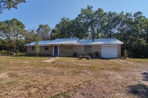 Your opportunity for private country living! This 1650 +- square foot home has all the amenities that you could ask for; shop, pond, view, 3 bedrooms, 2 bathrooms, one car attached garage, newer metal roof, newer heat air, and the list goes on! Home also has a small additional room in the front for an office, a covered back patio and 3 acres! Home is accessed via a private written easement across the neighbor to the west.