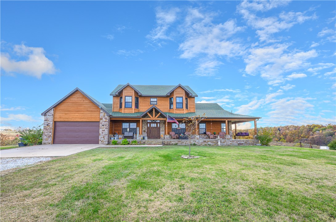 Experience peaceful country living on 18 stunning acres with beautiful views! This spacious 5-bedroom, 4.5-bath home features a gourmet kitchen with custom cabinetry, a stone wood-burning fireplace, and soaring cathedral ceilings. The open living area includes a wet bar—perfect for entertaining or relaxing evenings at home. The finished basement offers plenty of additional living space, ideal for a media room, game room, or guest suite. Roof was replaced 12/24. Enjoy the tranquility of nature all around you while still being a short drive to Gravette and Bentonville amenities. This one-of-a-kind property combines comfort, elegance, and privacy in a breathtaking setting. Contact Agent for details.