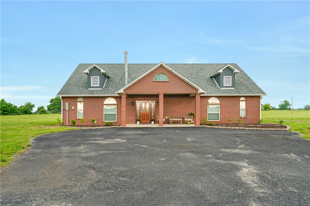 Set on nearly 9 acres of scenic land, this thoughtfully designed home offers a rare blend of privacy, space, and versatility. Designed for both everyday living and elevated entertaining, the home features a functional kitchen that opens to the dining and living areas, creating a comfortable and practical layout well suited for family life and gatherings. Three generously sized bedrooms and two full baths provide comfort and privacy, while an open upper-level retreat offers flexibility as a private office, reading lounge, media room or creative studio. Expansive windows and open sightlines connect the interior to the surrounding natural beauty, with recent updates including roof, driveway & underground electric and nearly nine acres of land providing room for outdoor living, future enhancements or peaceful retreat. Enjoy the peace of open skies with easy access to schools, shopping, dining, and everyday conveniences—a true blend of rural charm and everyday accessibility.