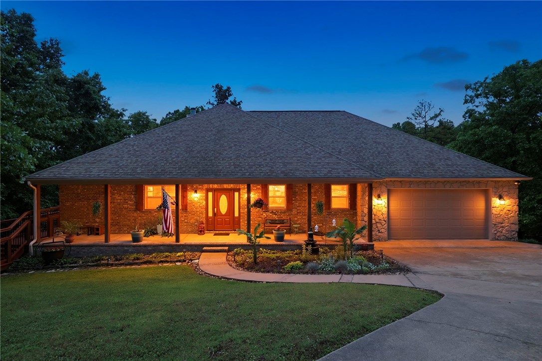 Beautifully maintained Beaver Lake lakefront home on 1.2 acres in The Point at Falls Hollow, offers both lake living & convenience just 10 min. from Downtown Rogers. This ranch home w/walkout lower level features open concept living, kitchen & dining areas designed for everyday comfort plus gathering w/family & friends. Updated kitchen includes sleek black stainless appliances. Main level primary bed & bath are both generously sized. Lower level is perfect for entertaining & includes a theater room, wet bar & large family room. 3-garage bays (2 main, 1 lower level) provide excellent storage for vehicles, lake toys & equipment! A covered porch, rear decks & fire pit provide plenty of outdoor living space to absorb the peaceful setting. A short 5-min. walk leads to the 10'x25' boat slip. The calm, quiet cove is ideal for fishing, swimming, paddle boarding or relaxing on the water. This combo of lakefront + comfortable floor plan + boat slip + close-to-town = highly desirable! (Cobalt boat & furnishings negotiable!)