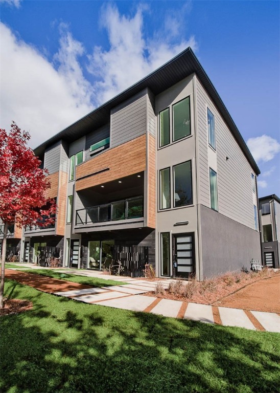 WELCOME TO DISTRICT 9/A! Modern living located across the street from Airship Coffee! Situated near the Crystal Bridges trail and the downtown square, this brand new corner unit offers both convenience and contemporary design. The property includes an attached 2-car garage and a community bike wash station, perfect for outdoor enthusiasts. Additional neighborhood amenities feature an outdoor grill and a fire pit, ideal for social gatherings. The contemporary kitchen is a highlight, featuring European cabinetry, exquisite quartz countertops, and a waterfall island. With modern fixtures and high-end finishes throughout, this condo exemplifies quality. Enjoy the elegance of glass balconies and the comfort of 3 luxurious bedrooms. The condo also includes 3.5 baths, designed with style and functionality in mind. Experience the ultimate luxury lifestyle with this exceptional property. Additional units are available.