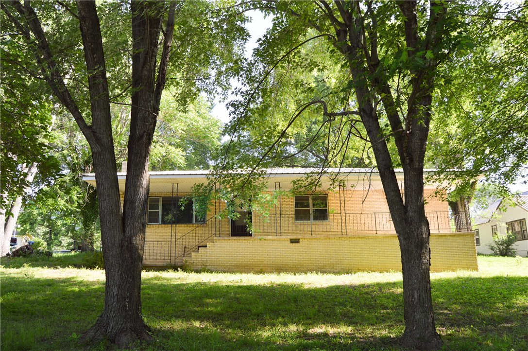 Newly remodeled 4 bedroom, 2.5 bath home on a corner lot. Walking distance to schools. New paint, carpet, & tile. Completely updated kitchen & bathrooms with stylish finishes. Gorgeous teak butcherblock counter tops with white subway backsplash. Restored hardwood flooring with charming wood burning fireplace in the living area. Sink in laundry room & built-ins in bedroom. This porch is just waiting for a swing. Bright & spacious, ready to move-in!