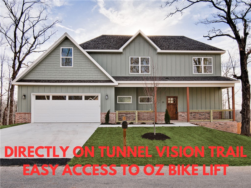 New construction with bonus room on a large wooded lot directly on Tunnel Vision Trail and close to Lake Windsor boat launch! Provides easy access to the OZ Bike Lift and Downtown Bentonville. You will be hard-pressed to find a better location. Step inside to discover a beautiful fireplace, custom cabinets, gas range, stunning waterfall island, and elegant 3 cm quartz countertops. This thoughtfully designed home features 3 spacious bedrooms plus a versatile bonus room, providing ample space for entertainment. The primary bedroom is conveniently located on the main level. Epoxy floors in garage! Bentonville schools! As an added bonus, this home includes $3,500 in buyer's closing costs when using the builder’s preferred lender!