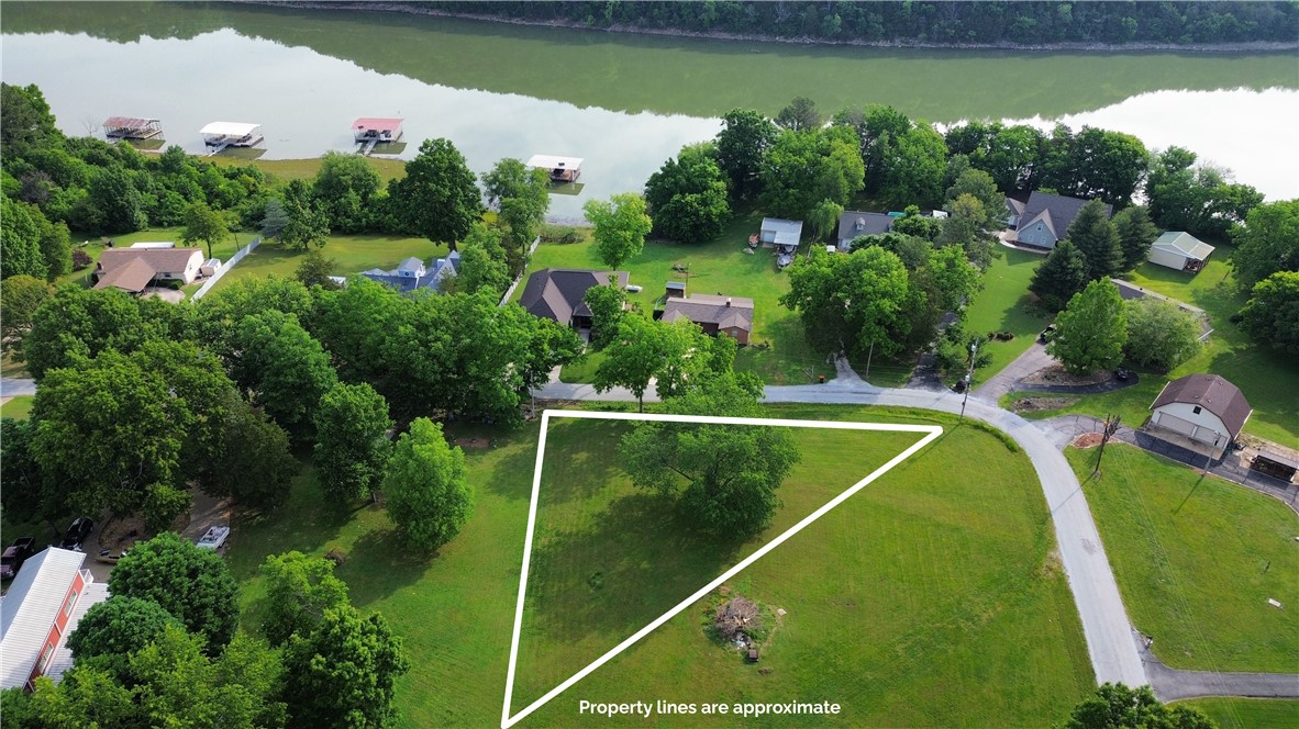 Build your dream retreat at Rochelle Riviera Lakesites. This exceptional 0.576 acre Beaver Lake, seasonal lake view lot, combines scenic beauty with an unmatched sense of community. Location is everything: enjoy serene, private lake living while remaining a short drive from downtown Springdale and commuting to Fayetteville or Bentonville is a breeze. This lot offers the ultimate balance of a peaceful sanctuary and urban accessibility. Outdoor adventure awaits right outside your door. Wake up to breathtaking lakeviews, head down the road to the public boat ramp for a day on the water, or take a short walk to the neighborhood's deeded easement. Whether you love relaxing by the water, swimming, or world-class fishing, this property is your gateway to the perfect lake lifestyle.