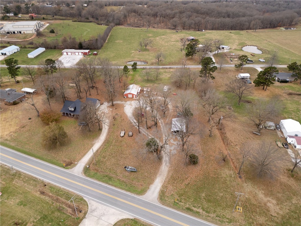 Prime building and business opportunity in Bergman—located directly across from Dollar General. This versatile 2.4± acre parcel offers excellent visibility with Highway 7 frontage, plus additional access from Southwest Street. The Southwest Street side may even be split off and sold separately for potential building lots or to build your dream home. The opportunities are endless. Included with the property is Rowe Woodworking, a well-established and highly regarded wood-furniture manufacturing business. Operating successfully since 1994, this turnkey operation comes with a 1,500 sq ft, well-insulated shop and a full lineup of high-end woodworking equipment. The business specializes in custom cabinets, cabinet doors, fine wood furniture, and more—boasting over 31 years of proven success.  Additional improvements include multiple outbuildings, a carport, equipment, and trailers.  Opportunities like this—prime location, flexible acreage, and a ready-to-run business—are rare. Come see the potential for yourself!