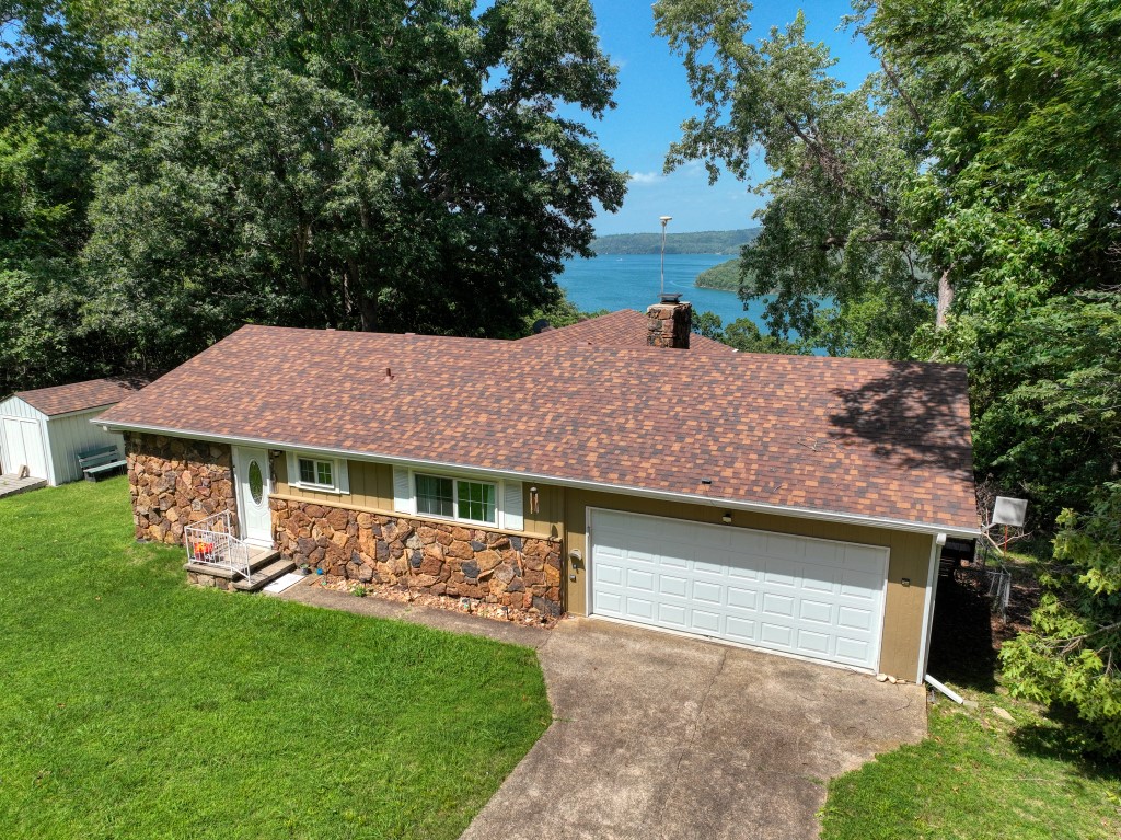 This cute home could be your Beaver Lake sanctuary! It’s perfectly situated on pavement off of Mundell Road, so it’s easy to get to, and it’s close to Starkey Marina! Several deck spaces and levels give this home a fun feel while you enjoy the privacy and great lake view. Inside offers a clean and open feeling that’s calming and inviting. The master bedroom and laundry are on the main floor which makes for easy living! The two-car garage is available to store your toys as well as a shed to store your tools. This beautiful home is located close to Eureka Springs, Beaver Dam, and the White River so you can play all day but come home to this peace and quiet and VIEW!