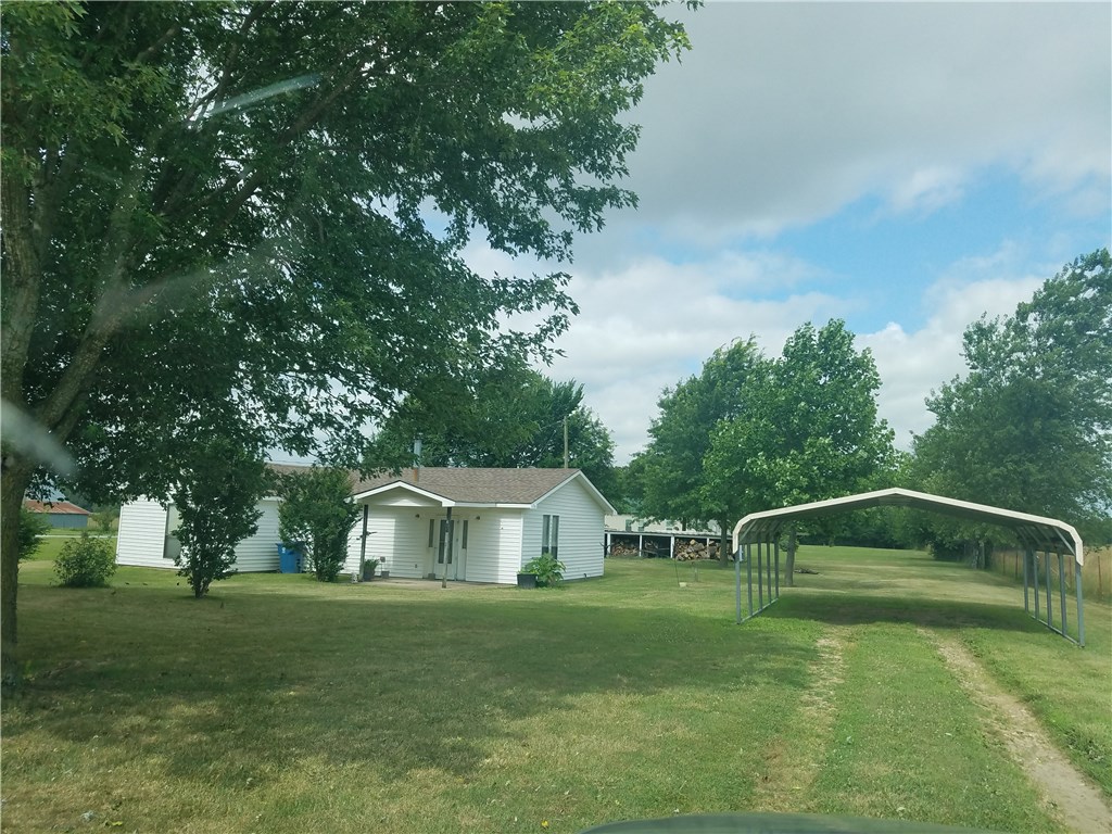 3 bedroom, 1 bath home , on over a half acre fenced!  Outside city limits.  Home has large bedrooms, open living room /kitchen/ dining area, large utility room. Roof is 3 years old  Shade trees, and some landscaping. Paved road  . All appliances and wood burning stove to stay with acceptable offer.