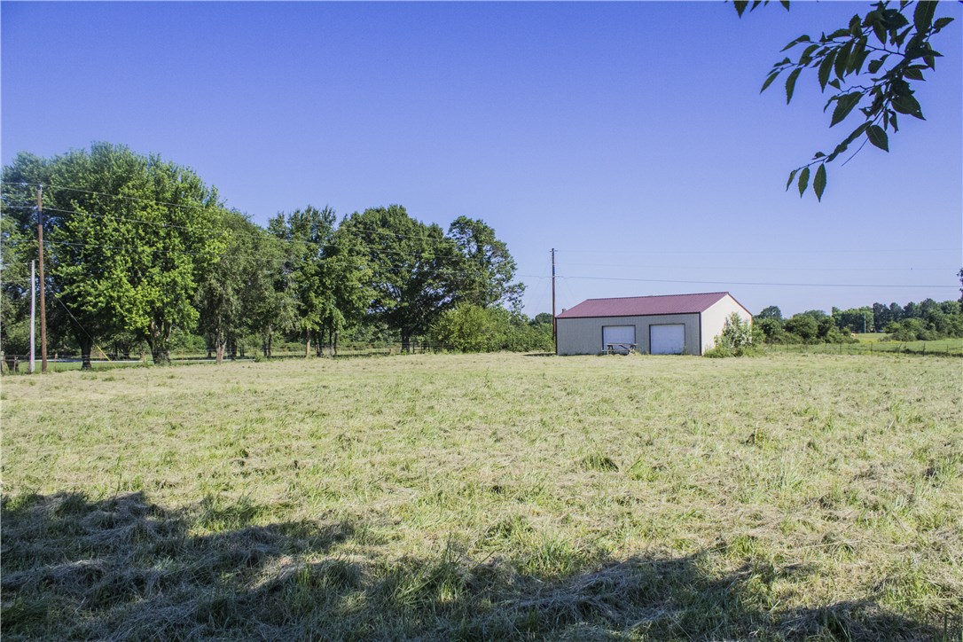 Nice level and cleared 2.5 acres ready for your dream home with a country feel  yet very  close to town. There is a 30X40 shop on nproperty. Electric and water by street, needs septic and propane gas.