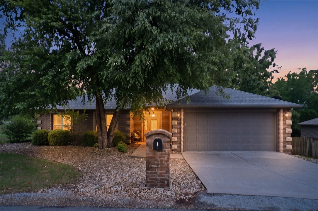 Rare one-level home with flat driveway & direct access to the Tunnel Vision Bike Trail in highly desirable Bentonville Schools! This move-in ready home offers freshly painted white interiors, abundant natural light soaring tray ceilings, crown molding, & a spacious open feel throughout. The inviting living room features gorgeous wood flooring plantation shutters, & a stunning stone fireplace perfect for cozy evening at home. The beautifully designed kitchen includes granite countertops, ample cabinetry, pantry storage, & generous prep space ideal for entertaining. Relax in the oversized primary suite w/walk-in shower. Enjoy peaceful mornings & relaxing evenings on the screened-in porch overlooking the level landscaped yard, in-ground sprinkler system. Major updates include architectural roof, remodeled baths, newer HVAC components, updated lighting, fresh paint, newer carpet, water heater, gutters, porch fan & more. Eash living on one level. Conveniently located near Lake Windsor, Oz Bike Park, biking trails etc.