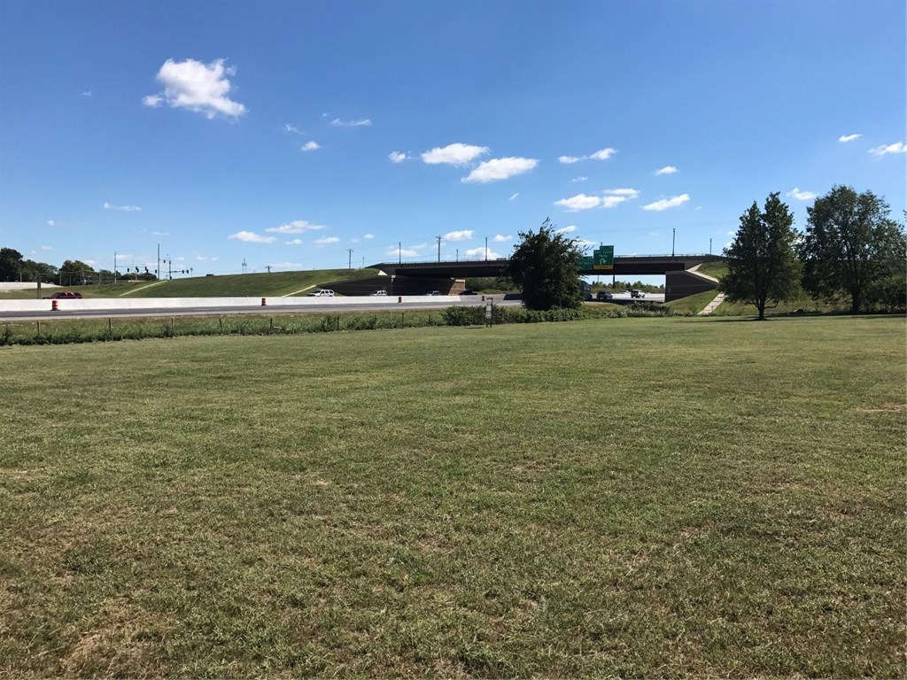 One of the last prime large corner parcels on I49.  This 8.79 acre flat parcel sits right on I49 and at the Northwest intersection on Don Tyson Expressway and I49 with a daily traffic count of 66,000 cars. Surrounding this parcel are the following Arkansas Children's Hospital and Sams Club shopping center currently under construction, Arvest Ball Park home of the AA KC Royals team the Naturals, and the future site of Northwest Arkansas Community College Washington County Campus. Priced to sell!