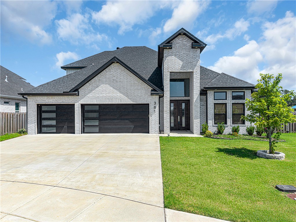 Welcome to Silver Leaf Estates, where luxury living meets effortless style. This stunning 2024 home offers 5 bedrooms, 3.5 baths, and 2,860 sq ft of beautifully upgraded living space, featuring quartz countertops, designer lighting, upgraded appliances, a soaring quartz fireplace, black-on-black windows, custom doors, glass-panel staircase, and spa-inspired baths. The striking white brick exterior, grand dark wood entry, 3-car garage, covered patio, and wood privacy fence complete the package. Silver Leaf Estates is known for its close-knit community, walking trails, community pool, playground, clubhouse, and dog park. Ideally located near everything Bentonville has to offer, including a vibrant downtown, the Walmart Home Office, a new Walmart Supercenter, shopping, dining, and more. Over $100K in upgrades. Seller is offering a 2-1 buydown so you can enjoy lower payments during the fist two years!