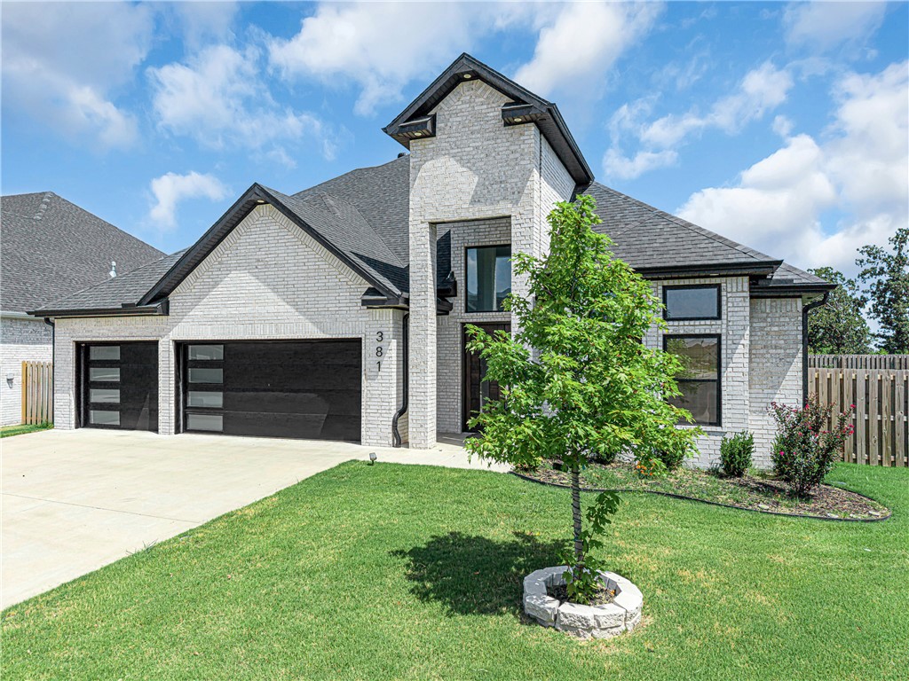 Welcome to Silver Leaf Estates, where luxury living meets effortless style. This stunning 2024 home offers 5 bedrooms, 3.5 baths, and 2,860 sq ft of beautifully upgraded living space, featuring quartz countertops, designer lighting, upgraded appliances, a soaring quartz fireplace, black-on-black windows, custom doors, glass-panel staircase, and spa-inspired baths. The striking white brick exterior, grand dark wood entry, 3-car garage, covered patio, and wood privacy fence complete the package. Silver Leaf Estates is known for its close-knit community, walking trails, community pool, playground, clubhouse, and dog park. Ideally located near everything Bentonville has to offer, including a vibrant downtown, the Walmart Home Office, a new Walmart Supercenter, shopping, dining, and more. Over $100K in upgrades. Seller is offering a 2-1 buydown so you can enjoy lower payments during the first two years!