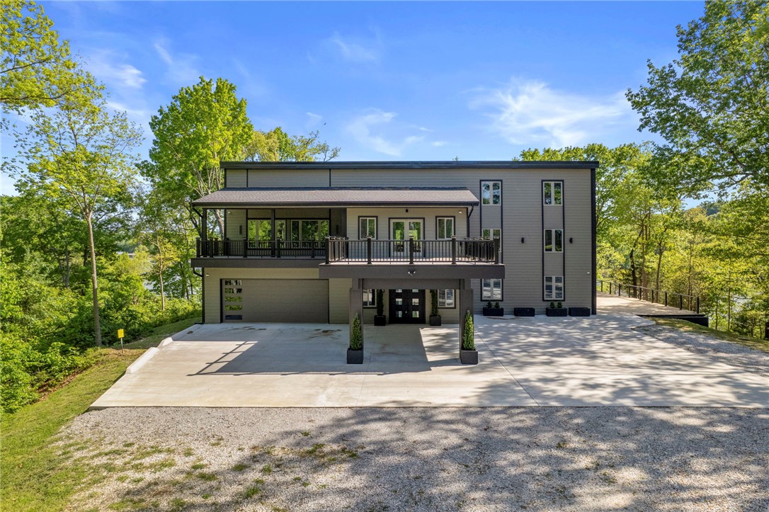 Beaver Lake Reserve, a lakeside family sanctuary on 7 park-like acres w stable. Be the 1st occupant, a complete remodel, ready to move in. In brand-new condition. Private entrance drive, 2 car portico. 2 new kitchens, 6.5 baths, level 5 paint, new roof, new Andersen windows & doors. Great room, 18-ft high Andersen window wall overlooking Beaver Lake. Architectural acoustical ceiling, custom fans in every room. Mezzanine overlooking great room & lake. Decks overlooking your grounds. 300' of easily accessible shoreline. 4 expansive bedrooms, 6.5 designer tile baths, 2 bonus rooms. ADA suite, custom children’s bedroom. Primary bedroom, spa bathroom, walk-in closet. French doors to lakefront deck. Two laundry rooms. Chef’s eat-in kitchen with grand island, waterfall bar seating for 5, custom cabinetry, induction cook tops (2), ovens (2), and sinks (2), adjoining large walk-in pantry. 4 car garage heated/AC, unlimited outdoor parking. 1000 sf of covered secure parking.