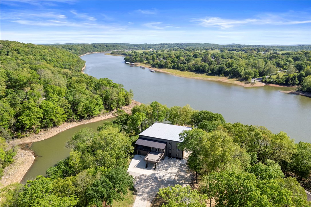 Exceptional private lakefront estate on 300’ of accessible Beaver Lake shoreline on 7 NW Arkansas’ park-like acres.  Top-to-bottom renovation, rare opportunity to own a luxury residence.

Your private drive to an estate designed for elegant everyday living and unforgettable entertaining.  A dramatic 18-foot window wall, panoramic lake views, great room with natural light for warmth and sophistication. Ideal for family or executive retreats, overlooking the lake, designed for comfort, privacy, and flexibility.

3 lakeview decks, 9,000 sq ft of beautifully living space, 6 bedrooms, 6 ½ designer bathrooms, 2 bonus rooms, 2 gourmet kitchens, ADA suite, primary suite spa bath, French doors directly onto the deck.  Components are new: Andersen windows/doors, roof, HVAC systems, custom finishes throughout, and level 5 wall finish.  New chef’s kitchen, custom cabinetry, waterfall island, dual induction cooktops, dual ovens, EIK for family and guests.

A rare move-in-ready luxury estate in NWA.