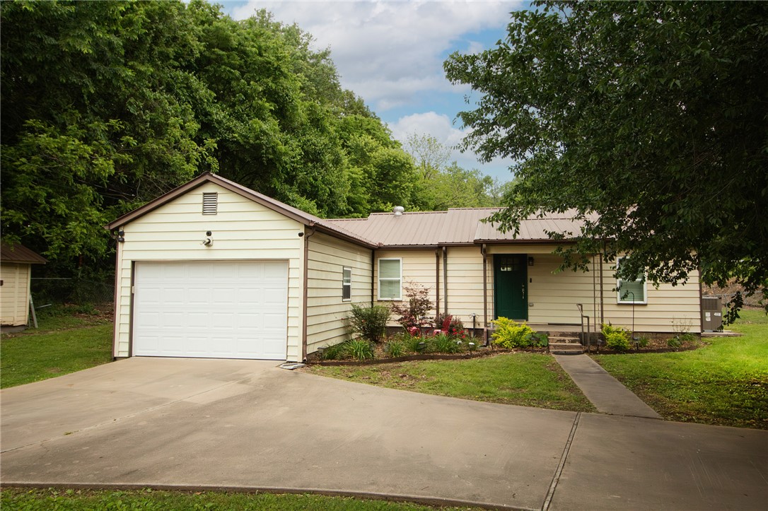 $2300 preferred lender credit with Stephanie Bevard at First Colony Mortgage. Updated and move-in ready!!! Major 2021 upgrades include upgraded electric, lighting, windows, HVAC, and a matching Whirlpool kitchen appliances. The interior boasts granite countertops, a kitchen island, tile backsplash, and wood vinyl plank flooring with tile in the dedicated laundry room. Modern touches include dimmable living room lighting, ceiling fans, OzarkGo high speed internet and a Nest thermostat. The primary suite offers a walk-in closet and tub/shower combo. 
Outside, the large yard is equipped with a storm shelter, a back shed, and a well house. Fayetteville Rural water is connected but it does have an unused private well. With all the updates throughout, this home is built for efficiency and low-maintenance living. Perfect for a first time buyer!