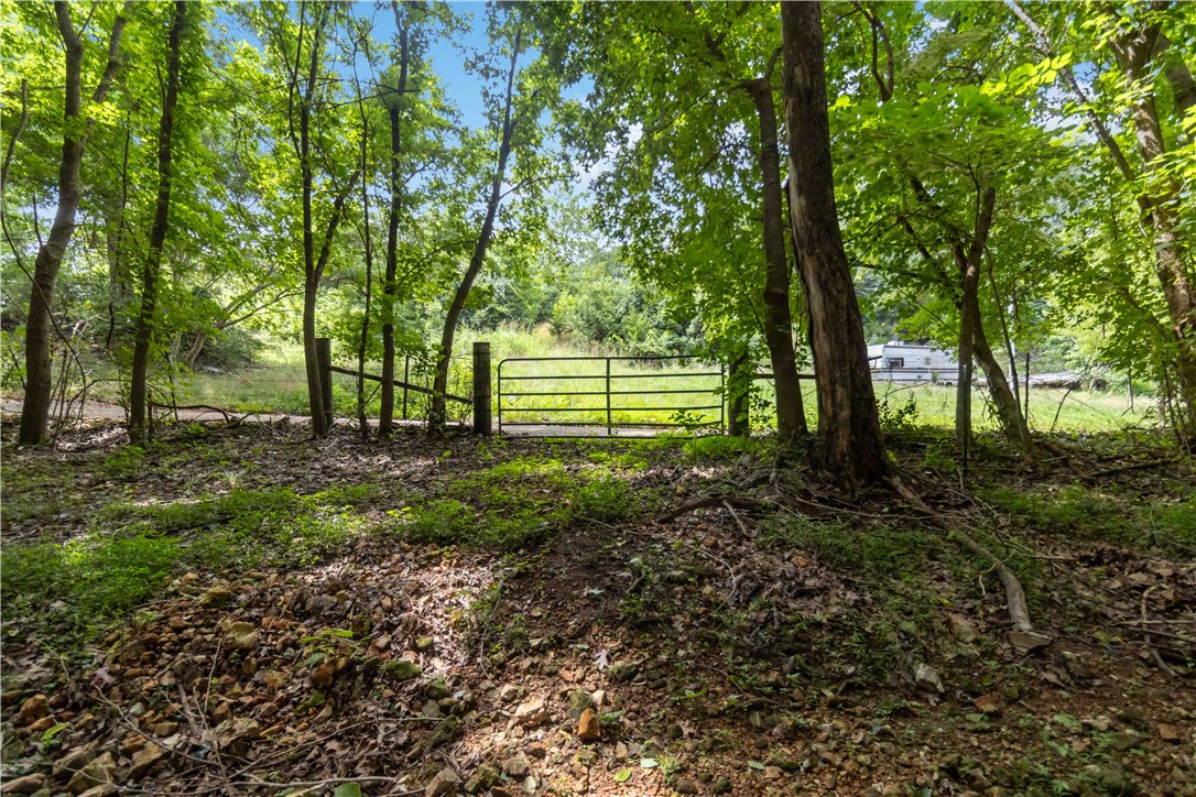 Discover the perfect balance of privacy and convenience with this beautiful 3-acre property on Davis Road. Tucked away in a peaceful setting with only a few neighboring properties, you'll enjoy a sense of seclusion while remaining just minutes from everyday amenities.

A picturesque stand of mature hardwoods creates a natural buffer from the road, leading you to a beautiful clearing that offers an ideal location for your future home. Beyond the homesite, the land gently slopes into its own private valley where you'll find a well-maintained workshop already in place.

Whether you're dreaming of building, creating a hobby farm, or simply enjoying the beauty of nature, this property offers a unique combination of wooded charm, usable terrain, and endless possibilities.   Please do not walk onto the property without notice or without being accompanied by an agent.  While it could be accessed, there is no water, no electric, septic would be needed and the seller has not had a percolation test done.