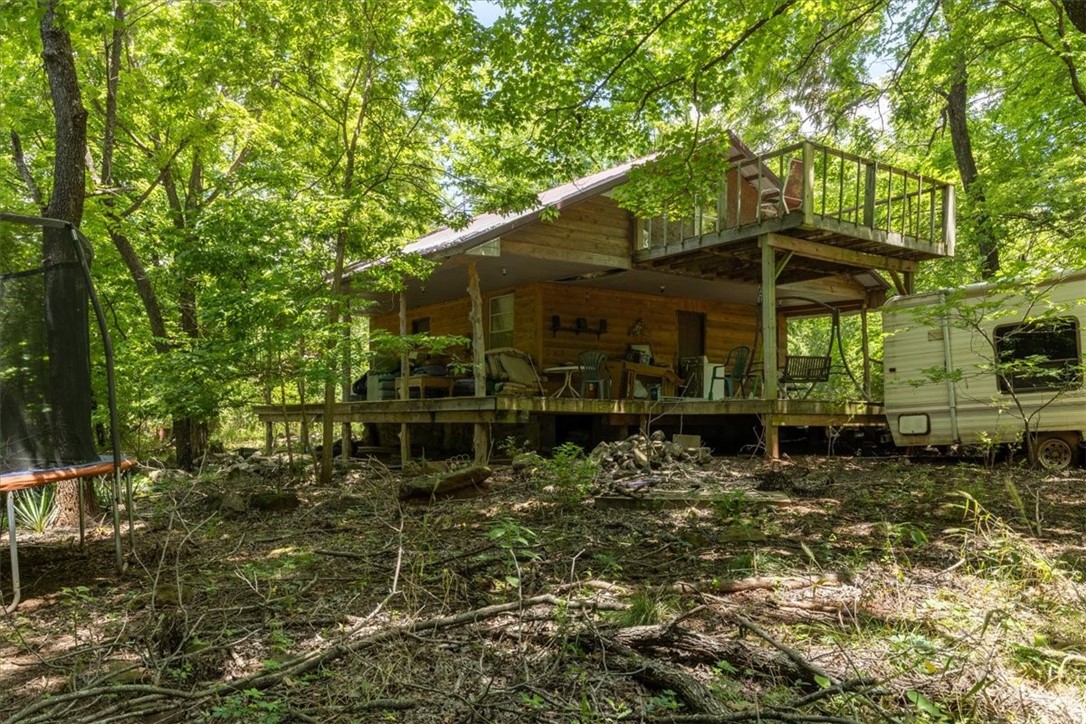 Over 5 acres in the shadows of the Boston Mountain. This home in the heart of the Ozarks is the perfect opportunity for someone to create their own place. Less than an hour from Fayetteville shopping & dining, escape the city life into your canopy of trees. Being sold as is it, where it is. Seller is trying to clean up some of the abandoned items, but any personal property items they can't get to will be left behind and transfers with sale. Don't miss this incredible opportunity! Information is deemed reliable, but not guaranteed. It is the buyer's responsibility to verify any and all information and confirm it as accurate. Don't miss the potential and possibilities of this property!