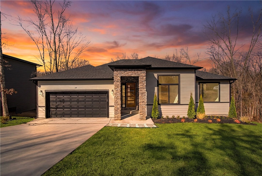 Look no further, this beautiful new construction home is perfectly situated in the heart of Bella Vista! Located in the Bentonville School District and just 15 minutes from the new Walmart Home Office, this home backs up directly to the Tunnel Vision Bike Trail, offering unmatched access to Bella Vista's renowned trail system right from your backyard. Inside, you'll find 10-foot ceilings, custom cabinetry, granite countertops, large windows, luxury vinyl plank flooring, and stylish modern finishes throughout. The open split floor plan is designed for functional everyday living, featuring a spacious primary suite and walk-in closets. The outdoor deck overlooks a wooded setting, ideal for nature lovers and those seeking privacy all while being close to daily conveniences.