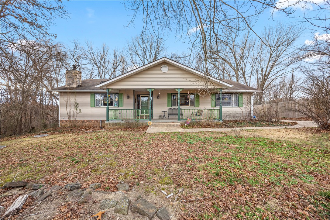 Bring your RV and mountain bikes to this well maintained, cozy, light-filled home close to Lago Vista MTB trail! Level lot with oversized detached garage (approx. 22'9" x 22'5") includes its own entrance, windows and attic storage. Long, flat driveway provides plenty of off-street parking for vehicles, trailers and toys. Enjoy sunsets from the back deck or large eat-in kitchen. New septic grinder/pump unit in 2025. Close to Towne Center shopping, Jane Walmart, Highland Gates retail, Bella Vista Country Club, Branchwood Recreation Center, and I-49 bypass. Home interior was designed for handicap access. Large bedrooms and so many windows! Home being sold as-is. Must see!