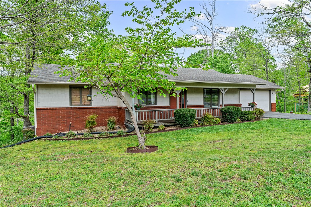 At the end of a quiet cul-de-sac, surrounded by mature trees and well-kept homes, this charming 2-bedroom, 2-bath home captures everything buyers love about Bella Vista. Located just moments from nearby trails, and close to golf courses and the renowned Bella Vista lakes, it’s perfect for those who enjoy an active outdoor lifestyle while still wanting a peaceful neighborhood setting.
A full-length covered front porch creates a warm welcome and the perfect place to relax and take in the natural surroundings. Inside, you’ll find a comfortable and functional layout, highlighted by a bright sunroom that offers versatile living space—ideal for morning coffee, a home office, or a relaxing end-of-day retreat.  
Additional storage space in the crawl space provides practical solutions for keeping things organized. With inviting curb appeal, a serene setting, and a price point that’s increasingly hard to find in Bella Vista, this home presents a unique opportunity you won’t want to miss.