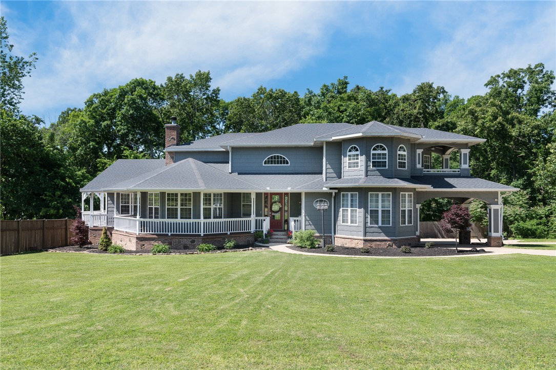 Enjoy exceptional outdoor living with, large pool with new liner (2025), wraparound front porch and cedar siding. Situated on 5 acres in a secluded subdivision just 6 minutes from Bentonville/Coler Mountain Bike Preserve. This home blends classic charm with modern updates, including a new roof in 2020. Perfect for entertaining - inside features hardwood floors, formal dining, formal living room with bay windows, fireplace, and french doors. The eat-in kitchen offers granite countertops, raised bar, electric cooktop, built-in oven and microwave, coffee bar, pantry, and abundant cabinetry. The adjoining family room includes beamed ceilings, built-ins, and a see-through fireplace with access to the porch. Main level (2,502 sf) includes a guest bedroom or potential primary suite, powder bath, and large utility room. Upstairs (1,593 sf) offers 3 bedrooms, full baths, and a spacious primary suite, private patio, tiled shower, soaking tub, and large closet. Walkout basement adds 1,155 sq ft, totaling 5,250 sf.