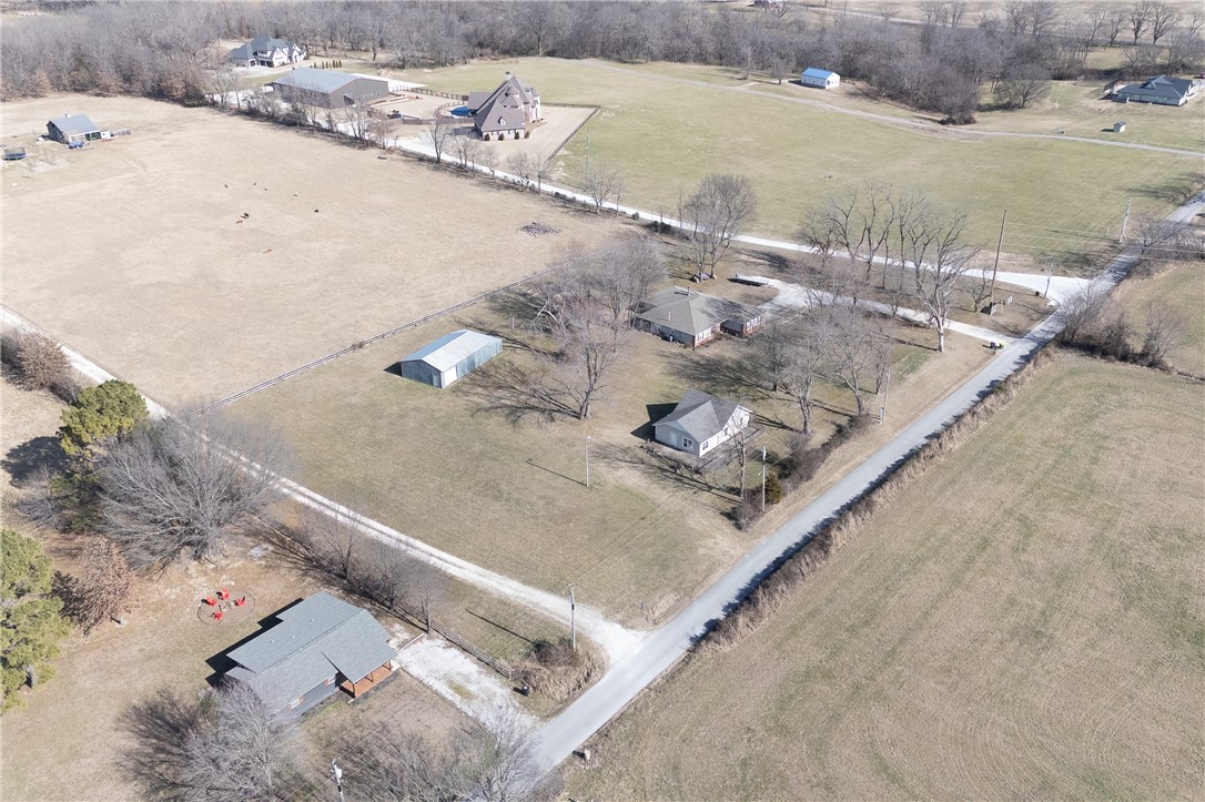 Rare opportunity to own 1.35± acres on Gibson Hill Rd in Farmington, ideally positioned just minutes from Farmington, Fayetteville, and I-49! The lot is flat and open, with only a few mature trees, making it a highly usable site for new construction! The property includes a large metal barn/shop previously used for hay storage, offering functional space for storage or a workshop. Electric and water are available on site. An existing septic system may be present; condition is unknown. An existing 2-bedroom home was left unfinished during a prior remodel and is not currently livable, creating an opportunity for buyers looking to start fresh. With acreage and a desirable, accessible location, this property is well suited for building or investment. Value is in the land. Property is being sold as-is. **Also listed as MLS # 1334652**