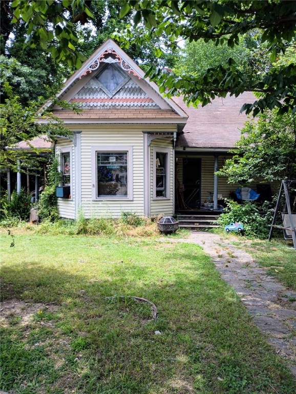 Here's your chance to own a piece of historic Prairie Grove, Arkansas. This century old house is close to everything in Prairie Grove. This corner lot is almost 1/3 Acre. Home needs considerable repairs. One official bedroom with 2 additional large bedrooms missing closets. Large living room with iron spiral staircase leading to upstairs bedroom and storage. Original stained-glass windows in some rooms. Refrigerator and window A/C units convey.