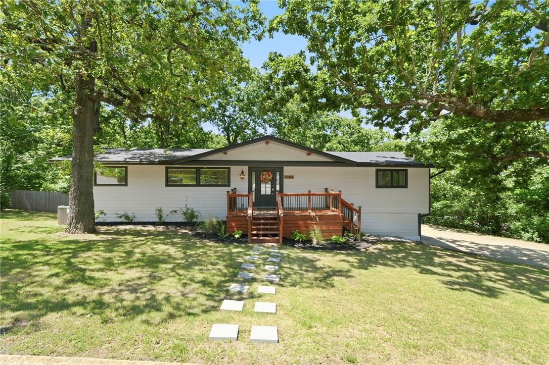 Great investment opportunity! Only a mile from UofA and Razorback sports. Completely remodeled in 2020 with new roof, siding, Pella windows, HVAC, hot water heater, and more. The kitchen features a large island with bar seating, granite countertops, stainless steel appliances, and a built-in wine fridge. The main floor primary suite is massive and includes a walk-in closet, a large jetted tub, and a walk-in shower. Downstairs has another living area, three additional bedrooms, and 2 full baths. A nearby trail at the end of the street connects directly to campus, adding even more convenience to this home. The fridge, washer, and dryer can convey with an acceptable offer. Home is being sold as-is.