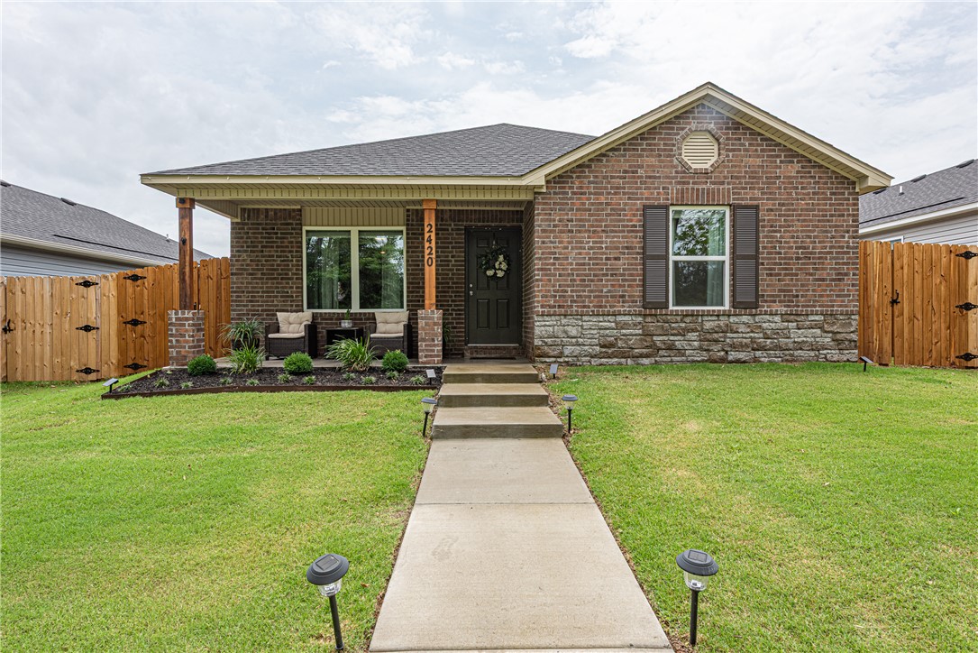 WELCOME HOME! This like new 3 bedrm 2 bathrm home w/ updated landscaping is located in Southeast Fayetteville min away from the University of Arkansas & downtown is near Stonebridge Meadows Golf Course, trails, and parks. From the covered front porch, head into open-concept layout that feat: LVP floors, custom blinds, curtains, & iron drapery rods throughout. Eat-in kitchen offers easy glide drawer pull outs in lower cabinets, ample cabinet space, & stainless steel apps including the refrigerator. Relax & rejuvenate in the primary suite with a walk-in closet & private ensuite bathroom. Two addt'l bedrooms provide flexibility for guests, family, or a home office. Enjoy views of the wooded area from the living space & take advantage of the paved walking trail located just beyond the front porch. Outside, enjoy the covered back porch for relaxation, a stained privacy fence, and an attached two-car garage! BONUS: Washer, dryer, & Blink Security System convey. This move-in ready home is one you won’t want to miss!
