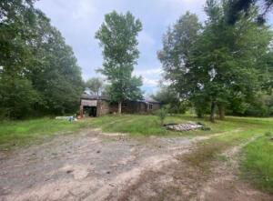 Enjoy a nice country setting on this shaded acreage. The property is mostly cleared and has lots of potential. Older home of no value located on property. Agents see remarks.