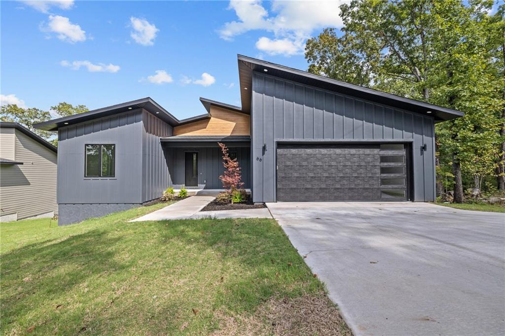 Welcome to 66 Glyndebourne in Bella Vista—a 2023 build offering contemporary design and natural surroundings with an adjacent lot available—ideal for added privacy or future potential. This 2-bedroom, 2.5-bath home with a large living area and flex space is located on The Ledges trail, with access to The Back 40 trail system. 

The home features a modern exterior, covered front patio, and an open back deck designed to take in the views, complete with a retaining wall and a level, covered storage area below.

Inside, you’ll find a functional layout for full-time living or a weekend retreat. The open living area offers flexibility with space for a home office without compromising flow.

Recent improvements include spray foam insulation and dehumidifier in the crawlspace, and an updated sprinkler system. Starlink internet service equipment, drapes, and rods to convey.

This is an exceptional opportunity to finally take advantage of the modern trailside living in Bella Vista—schedule your private showing today.