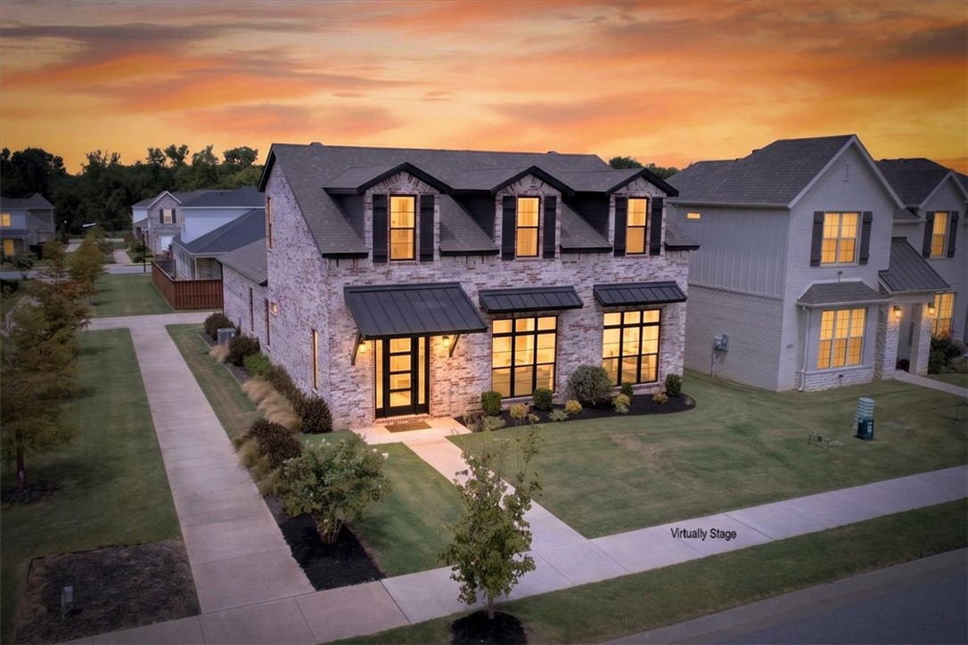 Some homes simply make everyday life easier. Whether you're enjoying coffee on the covered patio beside the outdoor fireplace on a quiet morning, hosting friends for dinner, or gathering around the kitchen island after a long day, this home was designed for the moments that matter most.

Life extends well beyond your front door in Aurora. Spend summer afternoons at the neighborhood pools, meet friends for a game of pickleball, gather at the clubhouse or picnic area for celebrations, enjoy the playground, let your four-legged companions run at the dog park, or simply take an evening stroll through a neighborhood designed to bring neighbors together.

Just minutes from shopping, dining, top-rated schools, and everything Northwest Arkansas has to offer, you'll spend less time commuting and more time enjoying home. Thoughtfully maintained and move-in ready, this isn't just a house, it's a place to slow down, gather with the people who matter most, & create lasting memories. Your next chapter can begin from day one.