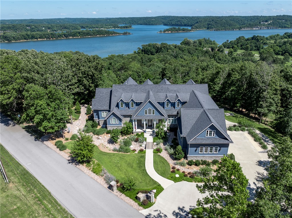 Few properties possess the setting, presence, and lifestyle to become truly iconic. Set atop a private 3-acre hill overlooking Beaver Lake, this extraordinary 8,501 SF estate commands breathtaking panoramic water views from 3 levels while offering the rare balance of complete privacy just 10 minutes from Downtown Rogers. Designed for effortless luxury, the home features 5 bedrooms, 6.5 baths, expansive gathering spaces & seamless indoor-outdoor living for both intimate family moments & grand entertaining. Extras include 3 fireplaces, exercise room, 3 laundry rooms, side by side garage, 20'x40' saltwater pool and spa, and gas fire pit patio.  A coveted boat slip with lift in a co-owned dock provides immediate access to Beaver Lake. Opportunities to own an estate of this scale, setting, and caliber are exceptionally rare. This is one of Beaver Lake's landmark residences—a legacy property created for those who expect the exceptional.  *Ask to see the complete list of features & upgrades.