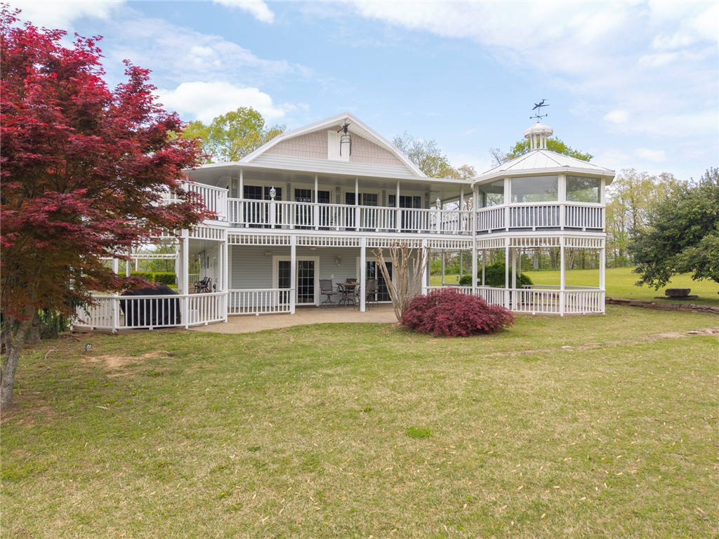 Meet 2428 Winn Mountain Loop- where custom features meet the tranquility of the Ozarks. This gorgeous 4,200sq ft home is nestled on 4.06 acres- 3BR/2BA-offering a secluded retreat sitting just minutes from town & the Winn Mountain Golf Course. The upper level is an entertainer’s dream featuring a 2nd full living room & kitchen- making it ideal for guests, multi-generational living, or unmatched entertaining. Throughout the upstairs, you'll find custom Teakwood flooring & ceiling—a true mark of craftsmanship- along w/ other custom details. Featured is the beautiful sunroom offering panoramic views of Mountainburg & the surrounding landscape. This custom room steps out onto a wrap-around balcony wired for sound, creating the ultimate outdoor entertainment area. Wind down your day soaking in the hot tub off the balcony overlooking the property. This home is a must see in person to appreciate the custom finishes and the truly breathtaking setting. Both refrigerators convey. Pellet Stove does not convey.