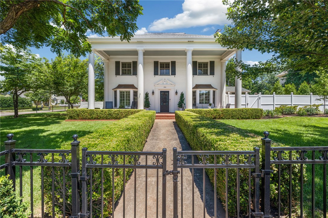 Positioned in Fayetteville’s historic Washington-Willow District, this 1937 full-brick residence sits on a prominent corner setting with private off-street parking. Capturing historic district charm and a thoroughly modern way of living, this 4,198 SF home's recent renovations include a fully finished and remodeled basement with a bonus room, flex room, ample storage, laundry, and a half bath. The main level provides a large, flexible layout for dining, living, and lounging, plus a gorgeous eat-in kitchen, light-filled sunroom, and an additional half bath. Upstairs, a recently remodeled primary suite is one of four bedrooms that each enjoy their own private bath, plus a second laundry room for convenience. Outside, a detached garage, newly fenced large front yard, and recently graveled and landscaped backyard with play set create inviting outdoor spaces for all ages. All within walking distance of Ozark Natural Foods, the downtown farmers market, and the heart of Fayetteville’s Washington–Willow Historic District.