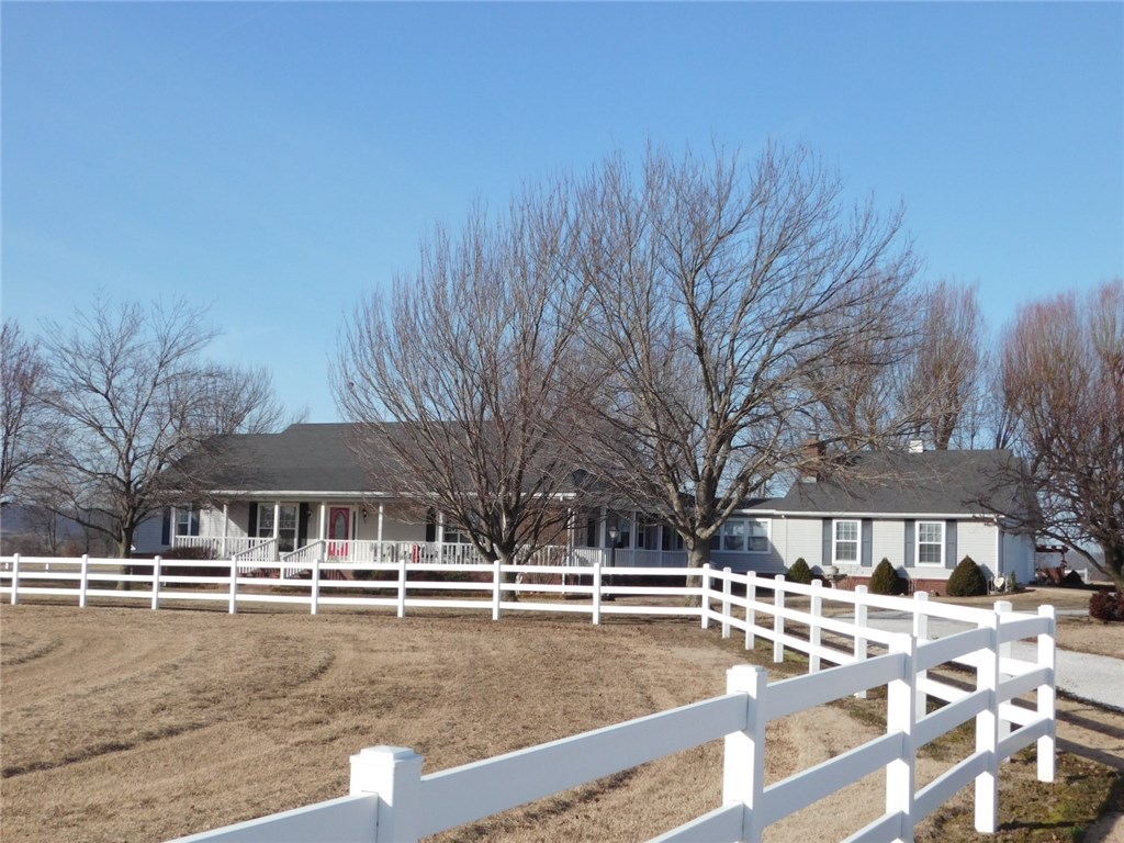 Pristine home on 5 acres with beautiful views! This spacious home features 2,821 sq. ft., 3 BR, 3 BA, office, huge walk-in closets, 6" walls, wood burning fireplace, double oven, oak cabinets and 2" blinds. It also has an electric dog fence and vinyl fence around the house. Located on a blacktop road just outside city limits. Not many like this one!