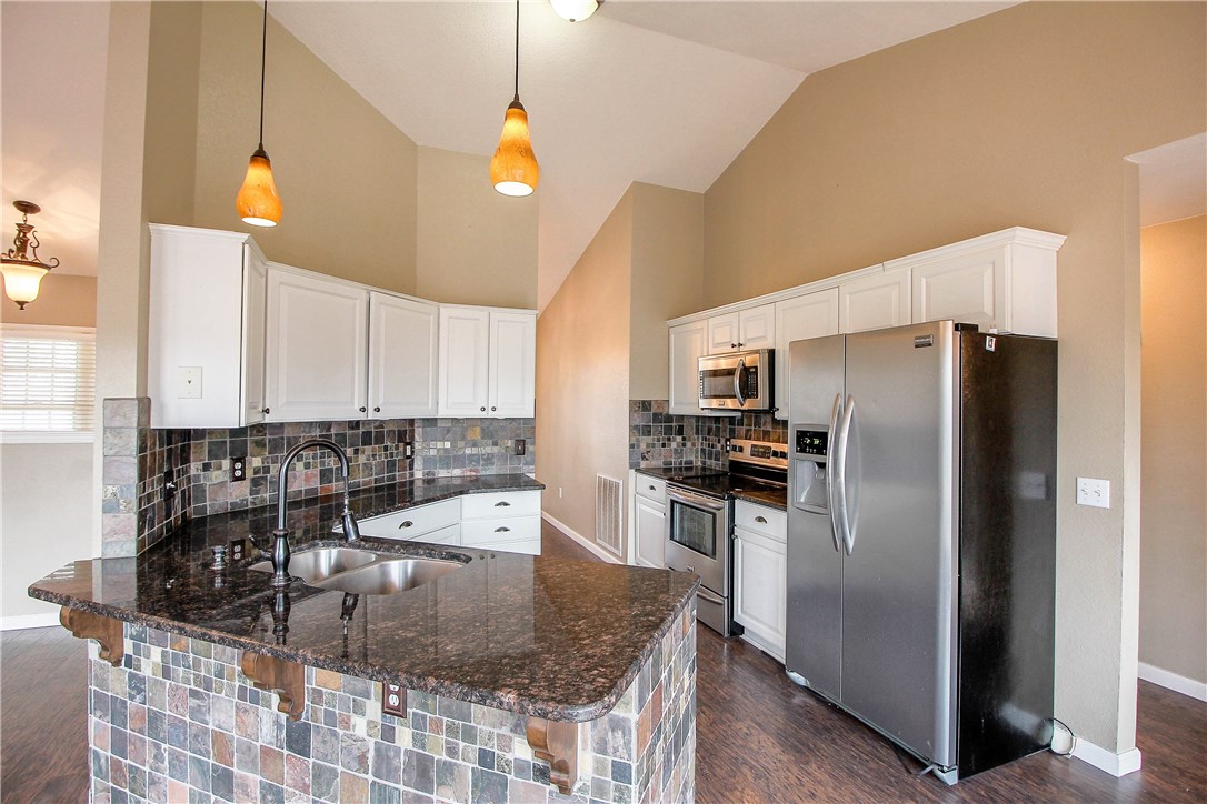 Looking for a spacious, affordable lake home close to town ?    Your new home offers 5 bedrooms, 3 baths  with an unbeatable location just 4 minutes to boat launch.   Second living area downstairs with kitchenette perfect for returning student or loved one.  Granite throughout with TONS of space and storage and YES a 3 car oversized garage !    Bonus Room downstairs perfect Man Cave, Lady Lounge, or Kids Game Room.  Grill and relax on your enormous back deck with views of woods and wildlife.   So much value at this price, don't wait !!!!!