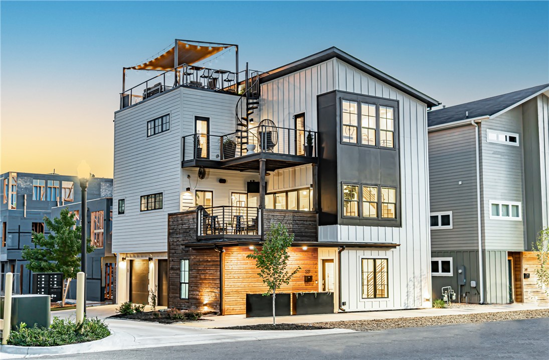 Showstopping home in Downtown Bentonville! This immaculate 3 bed, 3.5 bath home boasts designer finishes throughout that are sure to impress. The sun-filled main floor boasts an open concept layout with dining space, a living area, and a top of the line kitchen with an oversized island, built-in wine fridge, gas range stove, and beautiful countertops. Unwind in the primary suite showcasing a sliding barn door, patio access, and an ensuite bathroom featuring a large soaking tub and tiled shower. Additional amenities include a second seating area with fireplace and a spacious garage with epoxy flooring. This home is ideal for entertaining with its 2 decks and unique rooftop patio with 360 degree views of the downtown setting. Nestled in the heart of the Bentonville Arts District with immediate access to miles of biking trails and all that Downtown Bentonville has to offer, this home has everything you need and more. Welcome to your dream home!